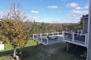 aerial view of newly remodeled deck on large hill overlooking tree grove